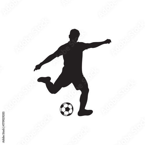 Silhouette of soccer player kicking ball in action