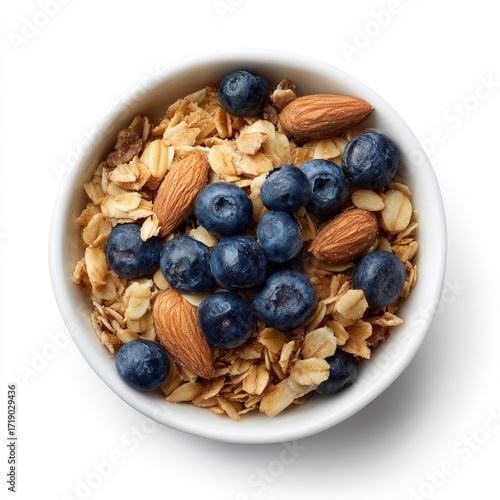 Top-down view of a small white bowl filled with granola, blueberries, and almonds