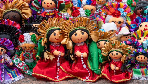 A collection of dolls with different colors and designs. The dolls are arranged in a row. Historic center of Queretaro City, decorations and traditions to celebrate Mexico's Independence Day, colonial