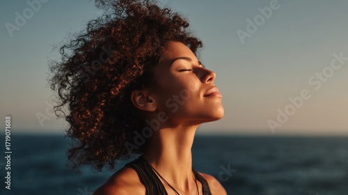 Embracing Serenity: A Woman Enjoys the Calm Breeze by the Ocean, Connecting with Nature and Embracing a Moment of Tranquility Under a Clear Sky