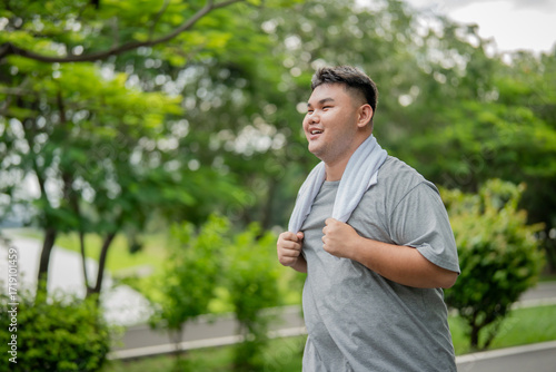 Asian plus-size man exercises outdoors in the garden to lose weight.