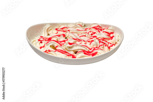 Dessert topped with airy whipped cream and strawberry syrup in a white oval bowl — a vibrant and appetizing sweet treat.