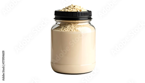 A clear glass jar with a black lid contains a beige powder; some powder sits atop the lid