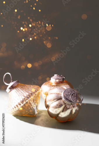 Christmas and New year festive banner with golden Christmas balls at green backdrop with shining particles and bokeh,