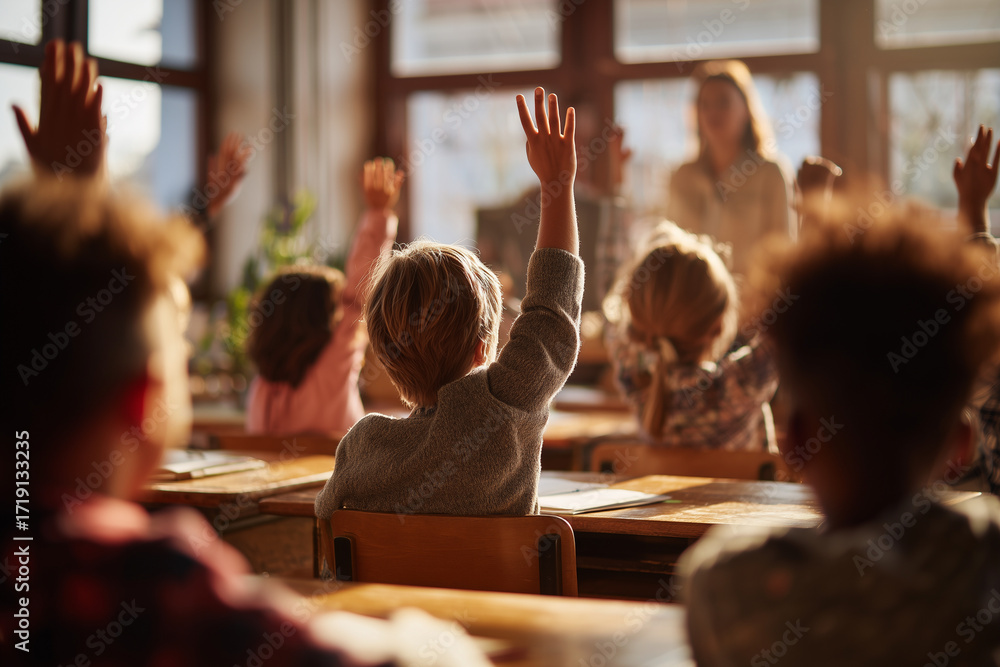 Fototapeta premium Elementary students eagerly raise their hands in a warm sunlit classroom, showing engagement, curiosity, and active learning during a lively lesson