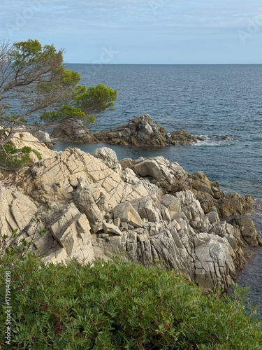 Rocky coastline cliffs with blue sea ocean horizon natural scenic marine landscape summer vacation travel seascape view