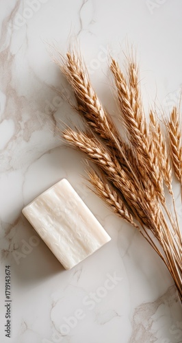 Natural soap and wheat sprigs on marble