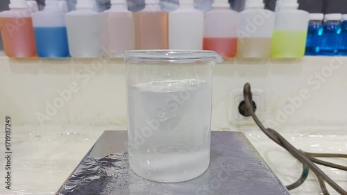 Dissolving Chemical Powder in Laboratory Beaker with Stirring Process