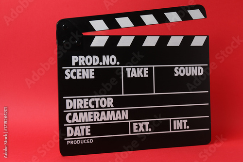 Cinema clapper and reel on a red background
