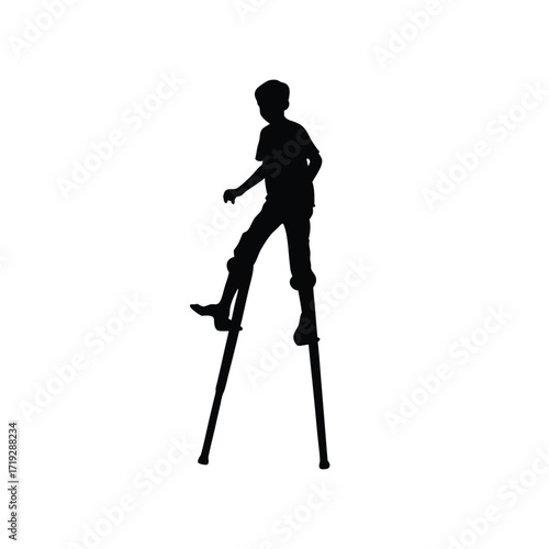 Silhouette of a boy walking on stilts against a white background in a full shot view image