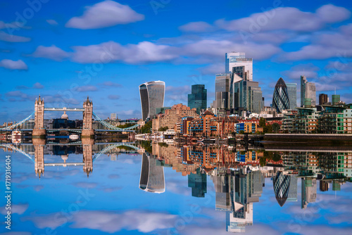 London City skyline reflected on the River Thames, a tranquil metropolitan beauty with modern high-rising architecture and Tower Bridge in the heart of the United Kingdom.