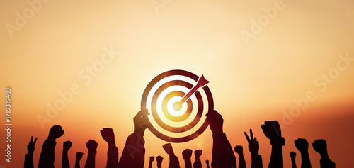 Teamwork for success concept. Silhouette of people raise your hands to show positive energy and target board on sunset background.