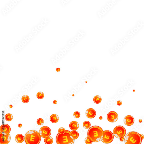 Vitamin E round capsules scattered randomly.