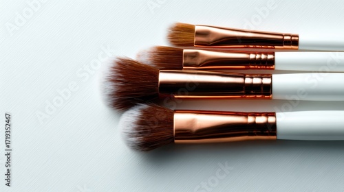 An elegant display of high-quality makeup brushes lined up on a sleek metallic surface, showcasing the artistry involved in cosmetics and makeup application.