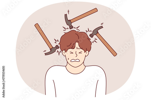 Headache and migraine torment man making painful grimace, standing among hammers. Problem of headaches caused by stress and noisy neighbors necessitates taking antibiotics and painkillers
