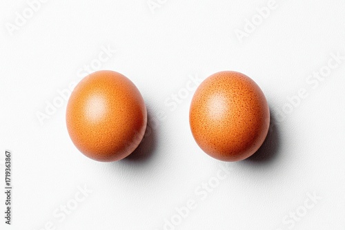 Two brown eggs on a white background