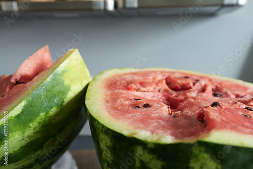 Watermelon cut in half on a kitchen table. Close-up.
