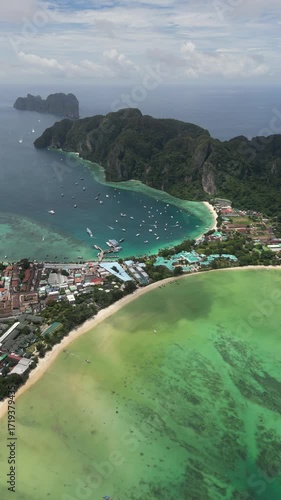 Drone video in portrait of Koh Phi Phi Don with Longtail Boats