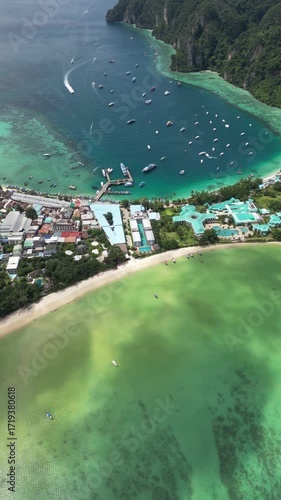 Drone video in portrait of Koh Phi Phi Don with Longtail Boats
