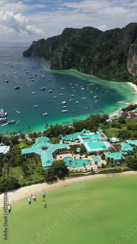 Drone video in portrait of Koh Phi Phi Don with Longtail Boats