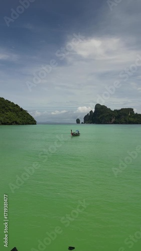 Drone video in portrait of Koh Phi Phi Don with Longtail Boats
