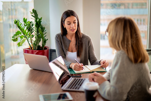 Business people sitting at office desk and working in a modern office