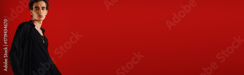Canvas Print Handsome man showcasing modern elegance with confidence against a vibrant backdr