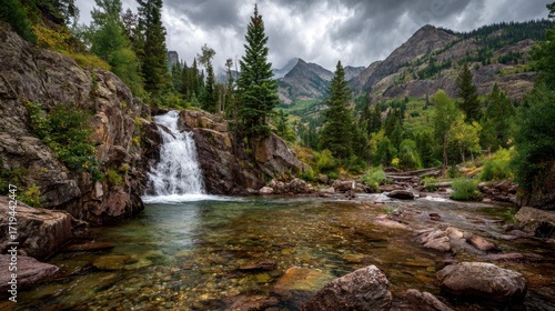 Scenic mountain landscape featuring a waterfall and a crystal clear mountain stream view in