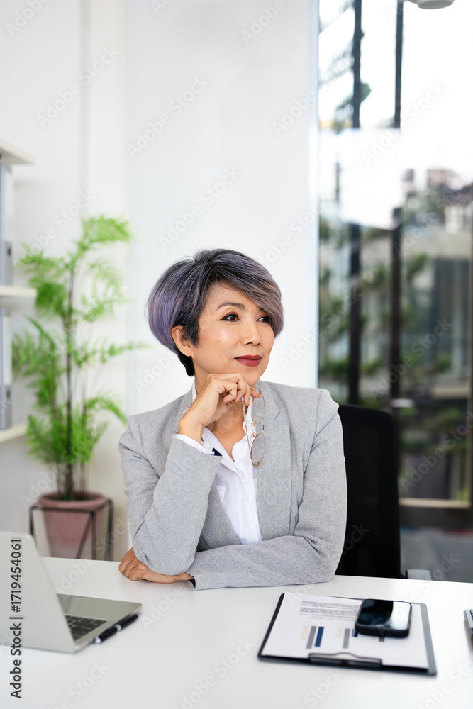 Obraz premium Happy dreamy mature senior business woman looking away at copy space and dreaming, planning. Smiling smart older 50s lady thinking of new opportunities vision .