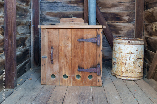 Wallpaper Mural Wooden box toilet inside an old timber outhouse. Sawdust can beside the toilet. Queensland, Australia  Torontodigital.ca