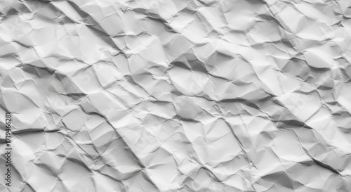 Abstract close-up texture of crinkled white paper folds and shadows