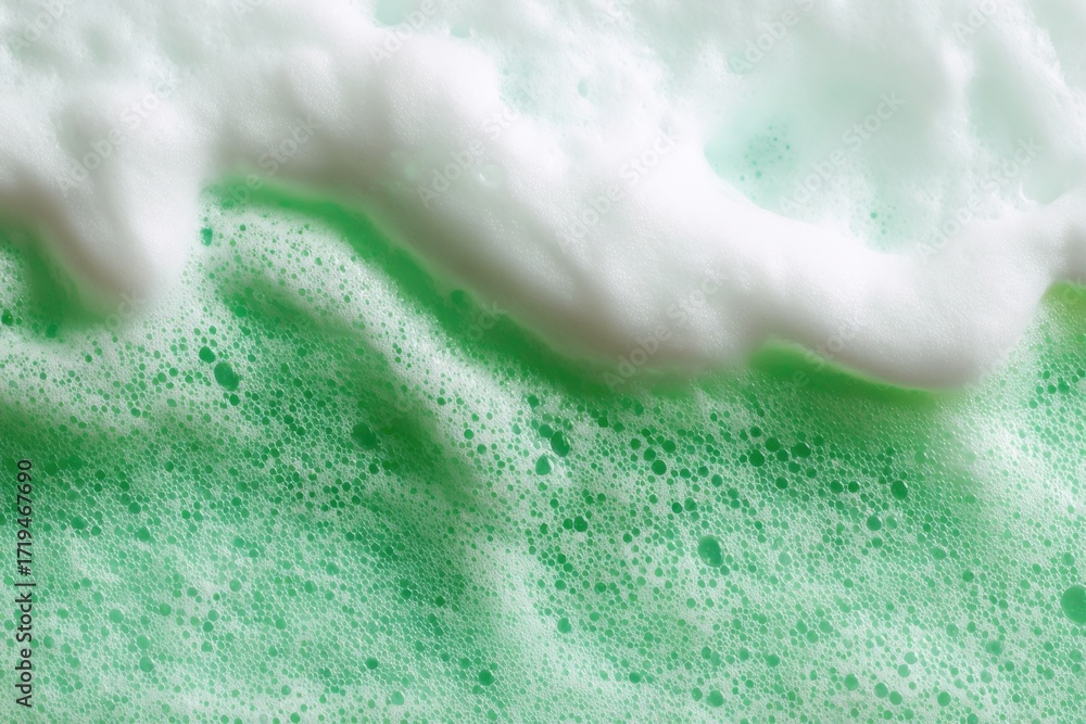 Fototapeta premium Beauty Product Foam Soap. Abstract background white soapy foam flowing texture. Shampoo foam with bubbles. Bubble surface isolated on a green color. Chroma key. Suds. Facial cleanser. Froth Pattern.
