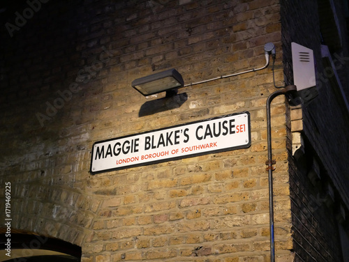 Bild auf Leinwand Maggie Blake's Cause street name sign on a brick wall in the London Borough of S