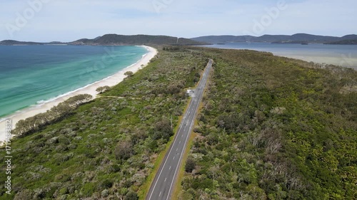 Wallpaper Mural Travelling along a coastal road heading towards a scenic headland between the ocean beaches and large lake system. Aerial view Torontodigital.ca