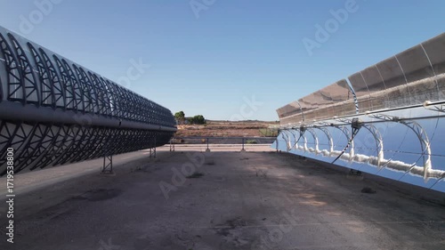 Solar thermal power plant with parabolic mirrors in a dry landscape. Renewable energy technology for clean electricity production and environmental sustainability.