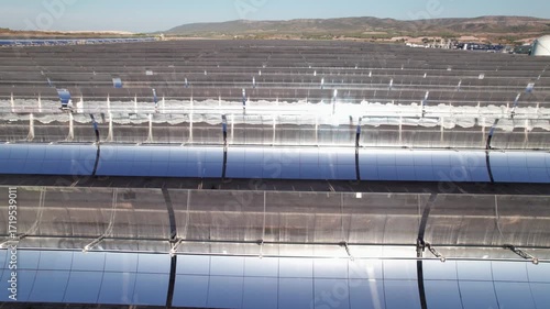 Solar thermal power plant with parabolic mirrors in a dry landscape. Renewable energy technology for clean electricity production and environmental sustainability.