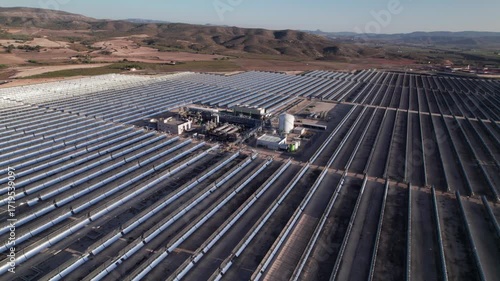 Solar thermal power plant with parabolic mirrors in a dry landscape. Renewable energy technology for clean electricity production and environmental sustainability.