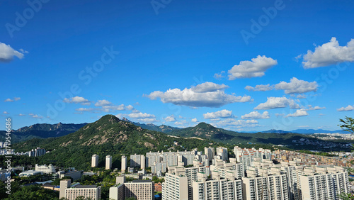 Cumulus clouds over city and mountains 도시와 산맥 위에 떠 있는 적운 구름