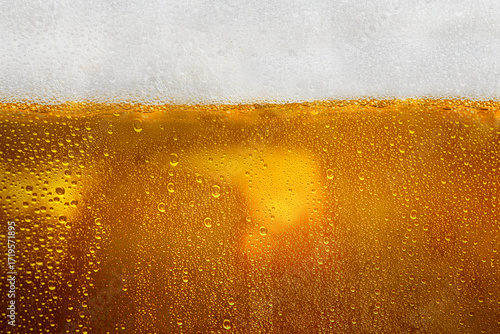 Photography Closeup view of refreshing golden beer with foam in a cold mug