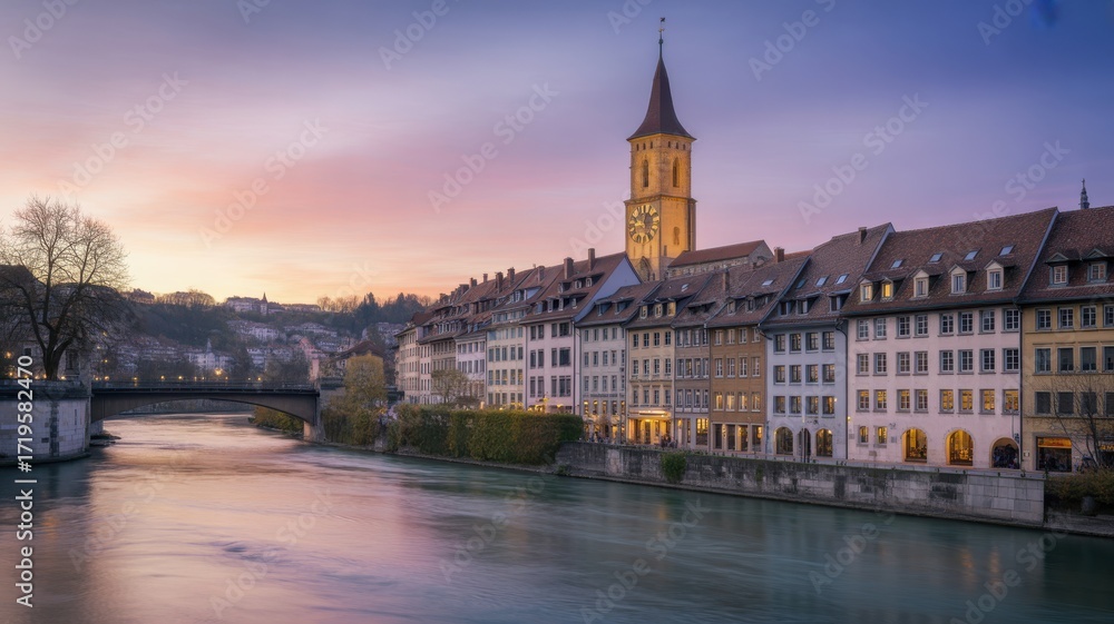 Naklejka premium Bern, Switzerland: A Picturesque Riverside Cityscape at Dusk with a Clock Tower