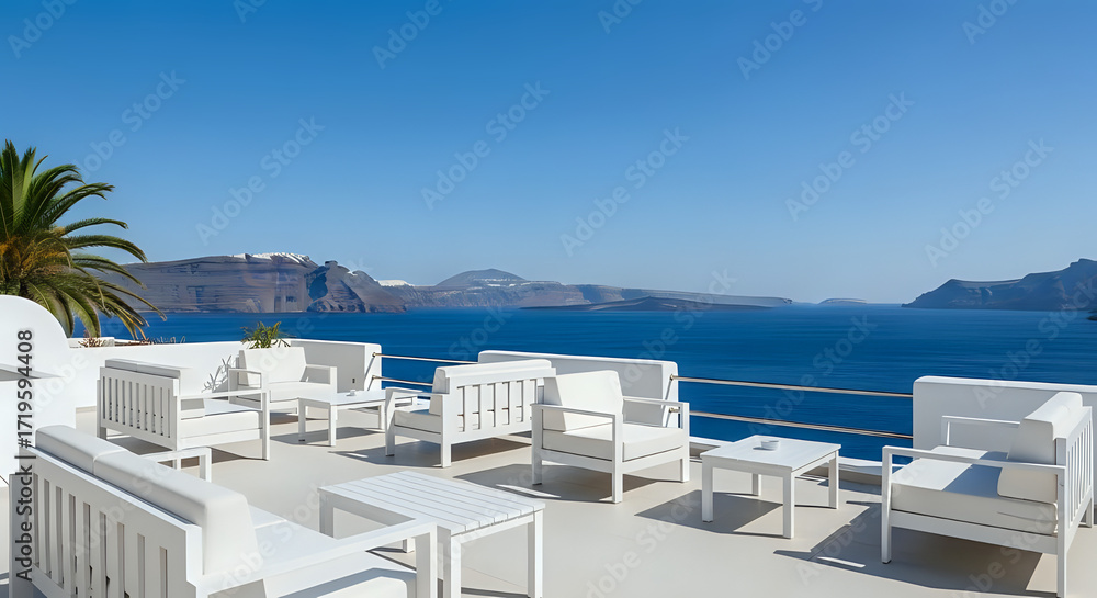 Fototapeta premium White furniture on a terrace overlooking the sea with a clear blue sky and distant islands view scene