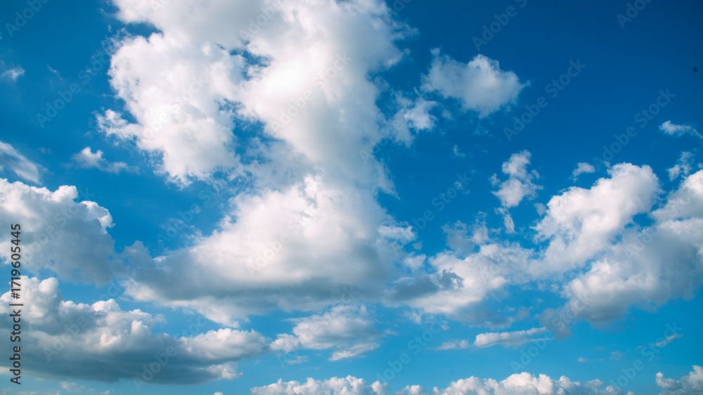 Fototapeta premium Blue sky fluffy white clouds on summer season bright clear skyline with beautiful cloudscape. Panorama blue sky clouds pattern on daylight with copy space. Cumulus cloudscape air climate sunny day