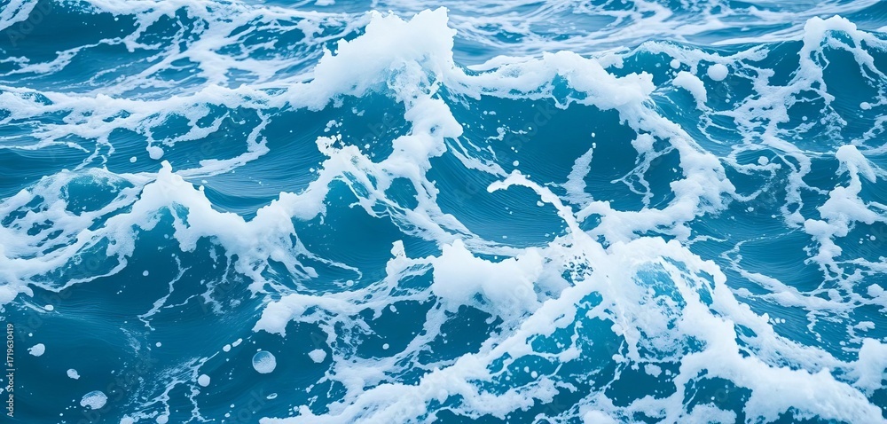 Fototapeta premium Close-up of churning ocean water, showing whitecaps and deep blue hues, energy, whitecaps