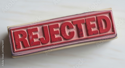 Close up of a red rejected stamp on a white surface angled