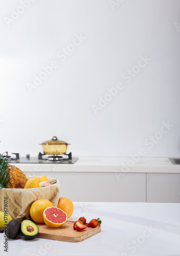 Still life of fresh fruits on wooden table in kitchen with soft lighting