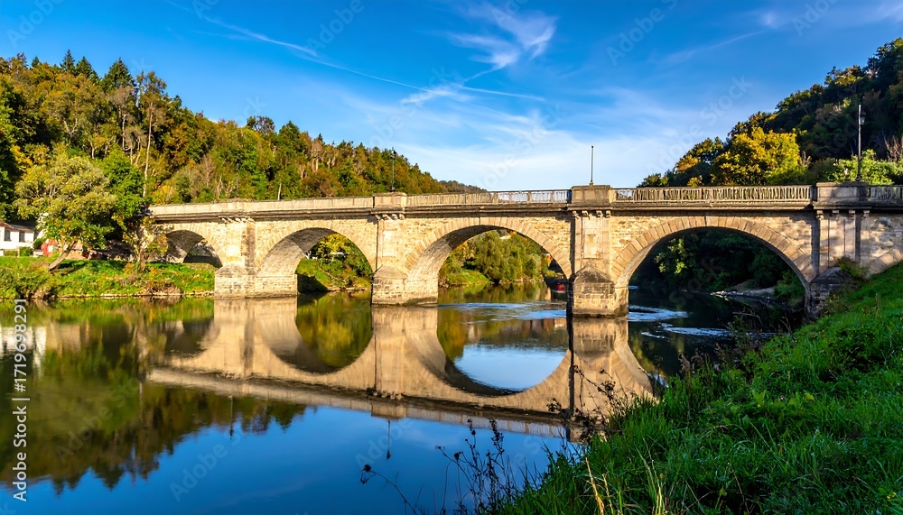 Fototapeta premium Stone bridge over a calm river
