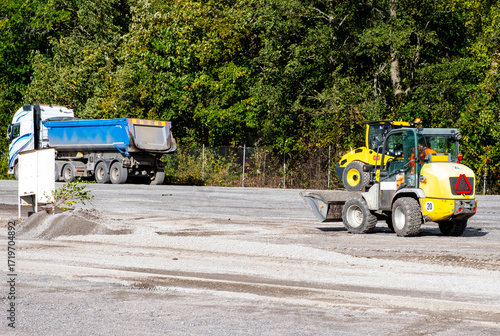 Road repair, vehicles and bulldozer paving.
