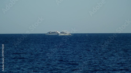 Tourist ships yachts sail towards each other and pass each other in the Red sea.