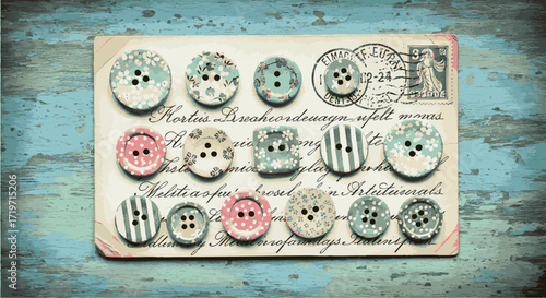 Vintage buttons arranged on a wooden surface with decorative elements in a flat lay view