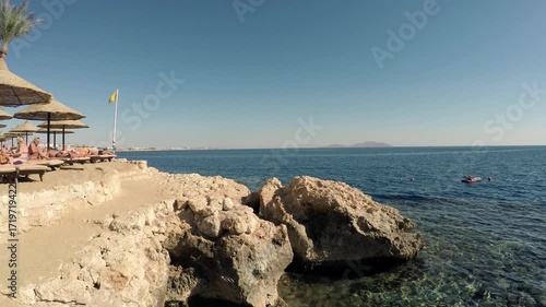 Vacationers on a picturesque Egyptian beach on the Red Sea opposite Tiran Island 